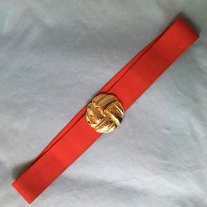 Vintage women's red elastic belt with gold tone buckle.